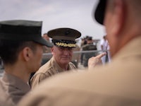 two men in military uniforms talking to each other