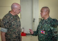 two men in military uniforms talking to each other
