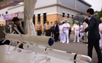 a group of people are looking at a missile on display