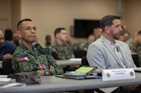 a group of military men sitting at a table