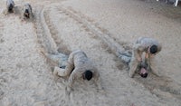 a group of people doing sand dune exercises in the sand