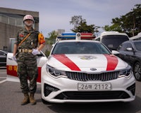a police officer standing next to a car